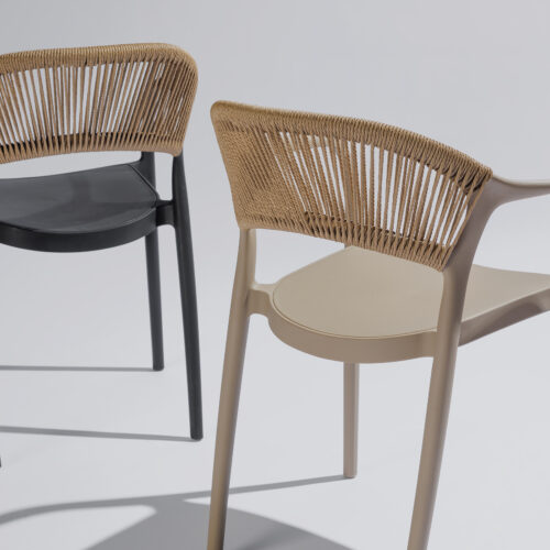 Hellen stoelen in twee kleuren stijlvol gefotografeerd in een harmonieuze compositie, met vooral zicht op de achterkant van de stoelen en focus op het elegante design en de verfijnde afwerking.