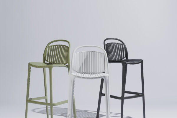 Three Strato bar stools in different colors stylishly placed in a harmonious composition in a photo studio with a neutral background and soft lighting, where the modern design and color combination take center stage.