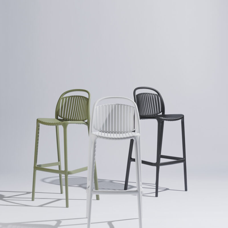 Three Strato bar stools in different colors stylishly placed in a harmonious composition in a photo studio with a neutral background and soft lighting, where the modern design and color combination take center stage.