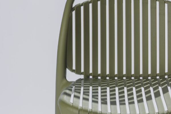 Detail image of the Strato chair in a stylish photo studio with a neutral background and soft lighting, where the refined finish, clean lines, and modern design take center stage.